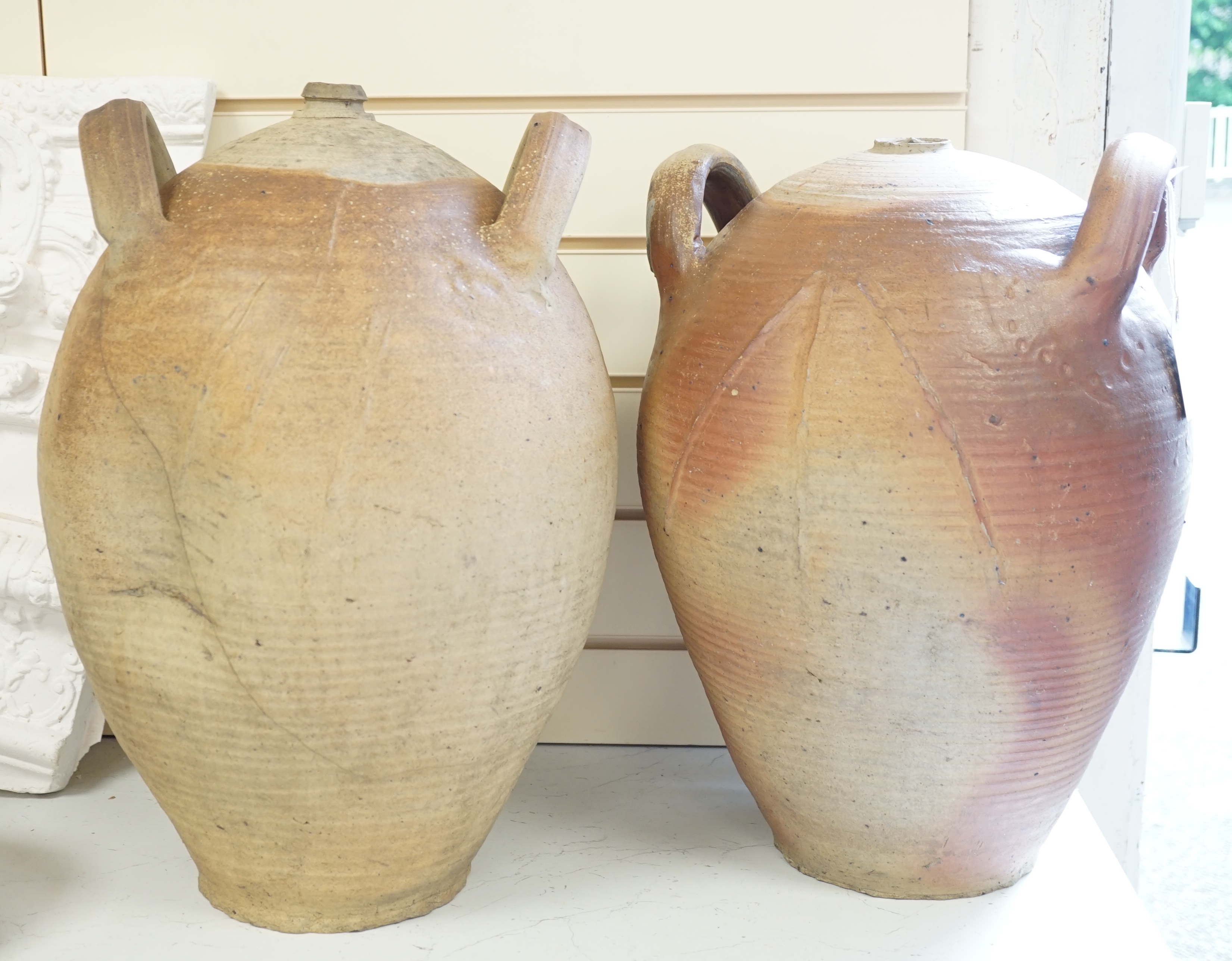 Two terracotta oil jars, tallest 49cm
